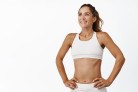 Smiling sportswoman in white sportsbra, with abs and muscles, looking pleased after productive training session, workout in gym, white background.
- (crédito: Seva Levytskyi) Smiling sportswoman in white sportsbra, with abs and muscles, looking pleased after productive training session, workout in gym, white background.
- (crédito: Seva Levytskyi)